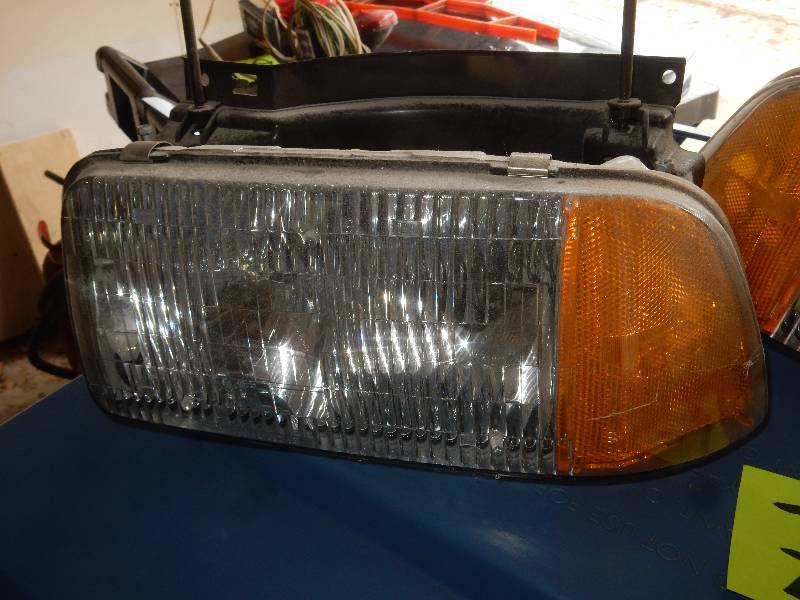 lot 79 image: pair of headlights.. Entire assembly seems to be there.