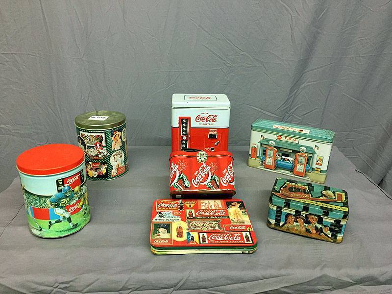 lot 21 image: Coke trivets and tins