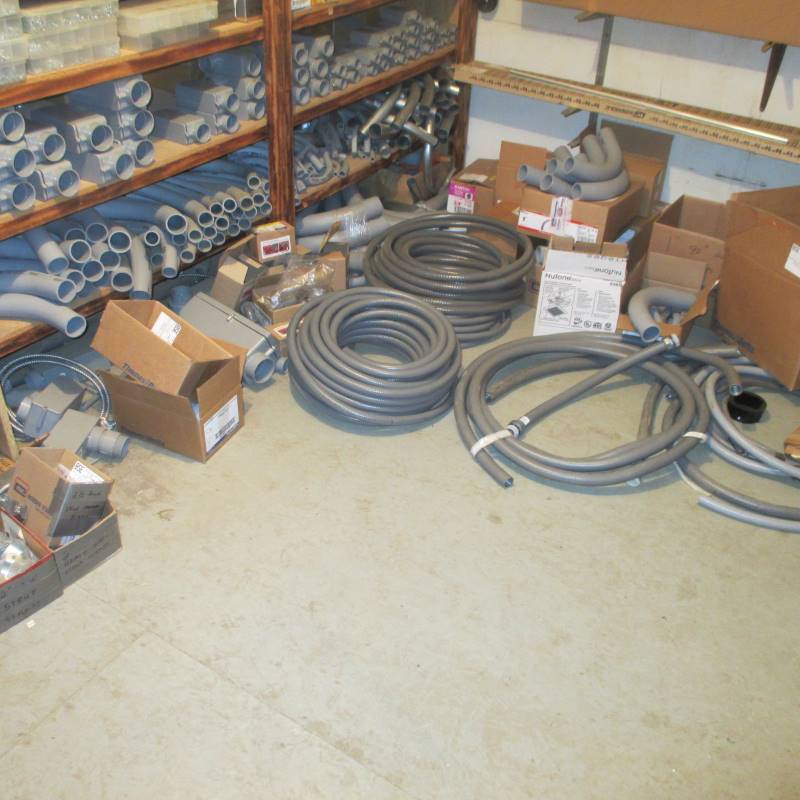 lot 69 image: Contents of Bottom 2 Shelves of PVC Conduit & Boxes, Conduit Rolls