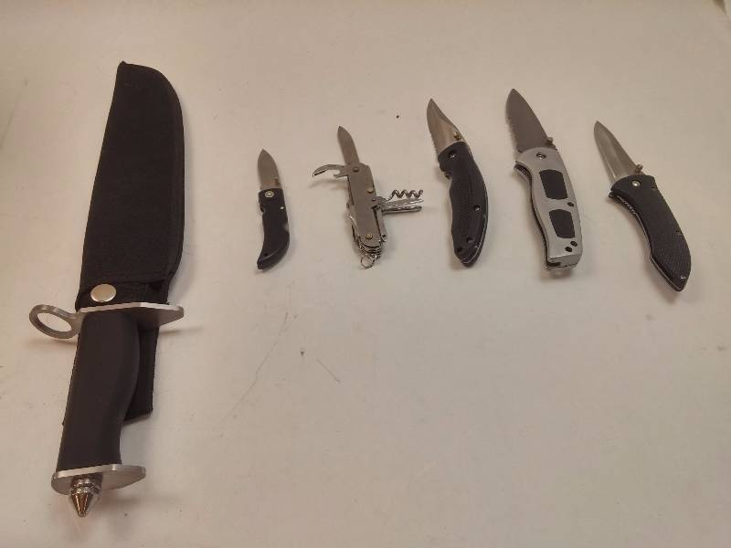 lot 839 image: Lot of 6 Various Knives Generic long Stanless Bowie Knife with Sheath, Silver Gray Frost Flip Knife, Apache Black Stainless Flip Knife, Frost Black Stainless Flip Knife, Frost Barracuda Flip Knife, Generic Multi-tool