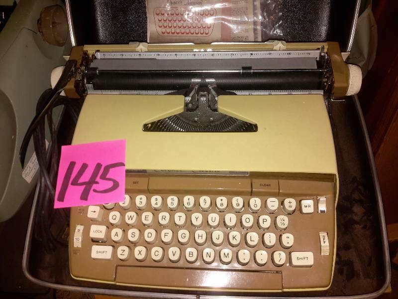lot 145 image: 3 Older model Electric typewriters plus table.