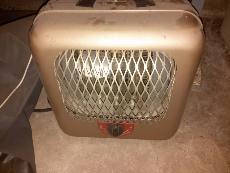 lot 156 image: Misc. items on the shelf in the basement as pictured. Includes Vintage Royal typewriter, electric heater, Mid century style kitchen clock, Decorative items and bulbs as pictured.  Bring your own Packaging.