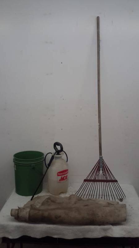 lot 52 image: Rake, weed killer in sprayer, 5 gal bucket, shop blanket