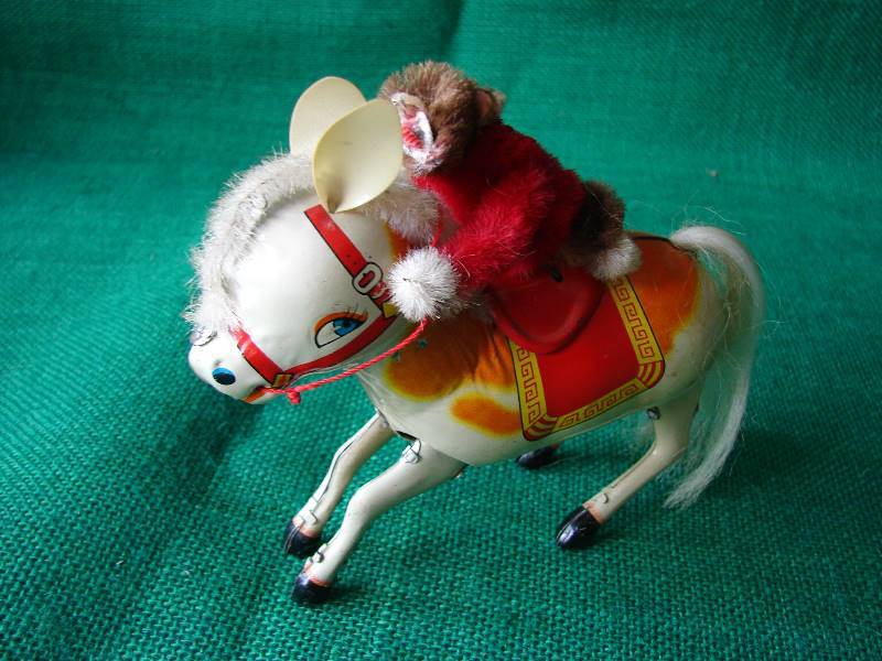 lot 109 image: Vintage Monkey on a tin horse.(Very OLD)