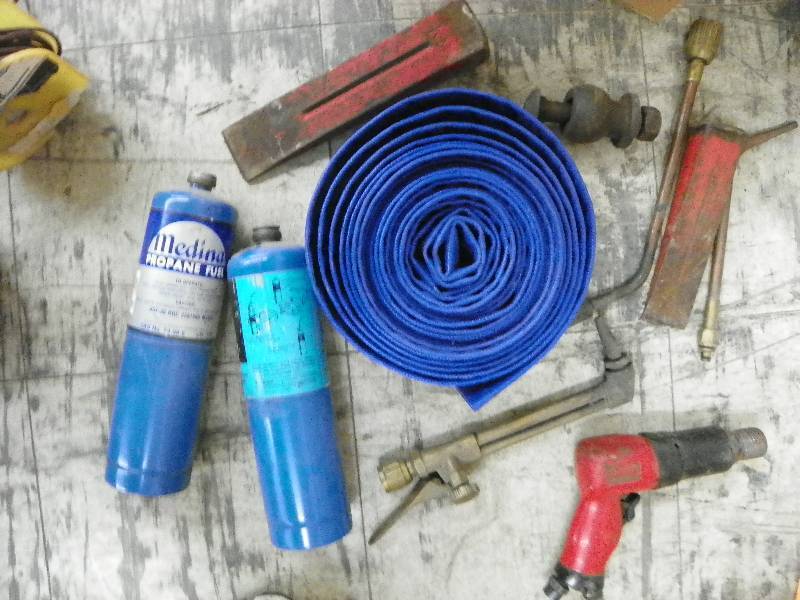 lot 548 image: blue sump hose, drill, metal wedges, propane tanks, and other misc