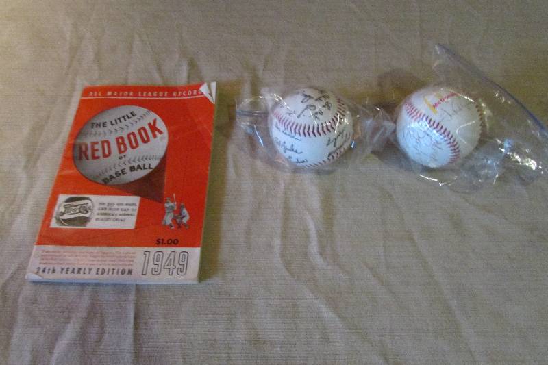 Baseballs and a Old Baseball Book