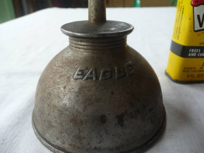 lot 32 image: 3 Vintage Never Opened (Metal) Clark Quart Oil Can 1 Antique Eagle Oiler 1 Vintage Liquid Wrench Can 1 Vintage Tile Cement Can - See Pictures
