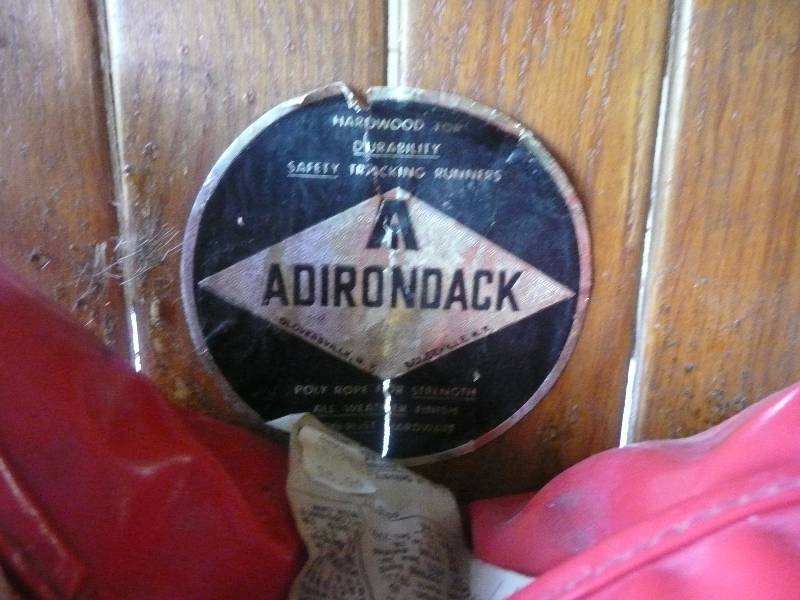 lot 44 image: Antique Adirondack Wood Taboggan - Poly Rope & Seat Cushion - No Rust On Hardware - Foam On Curve To Prevent Injuries - Excellent Shape - Rare