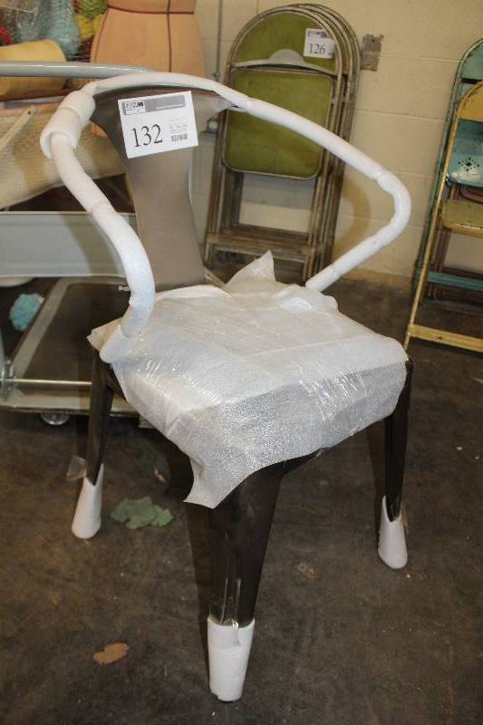 lot 132 image: New stock reproduction Tolix arm chair. Custom cushion. Easy to re-upholster. Current fabric is vintage inspired.
