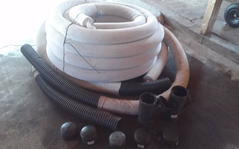 lot 12 image: 100FT Drain Tile Roll with Sock, Plus extra fittings