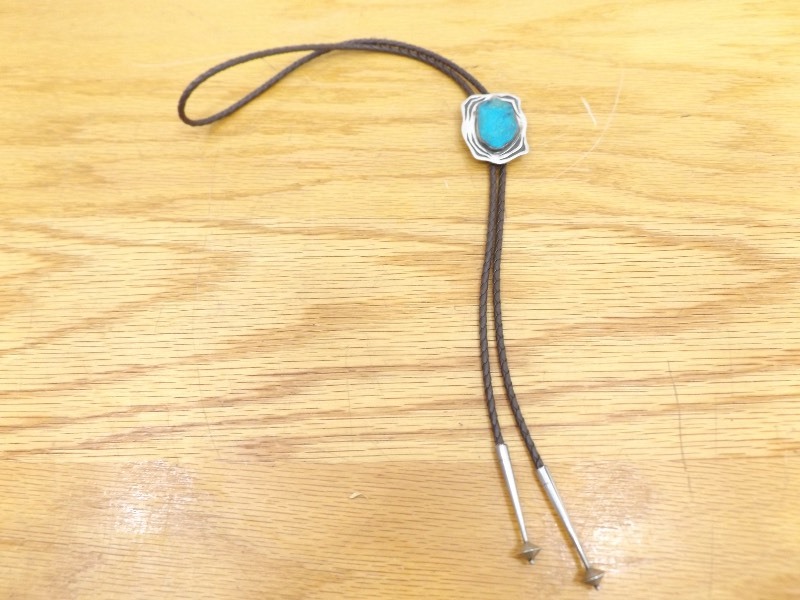 lot 35 image: Leather Bolo Tie with Sterling Silver Pendant, and Tips (1.524 oz Total Weight)
