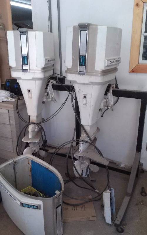 lot 8 image: Lot - Chrysler Outboard Motors, both are 70hp, Comes with heavy duty rolling stand.
