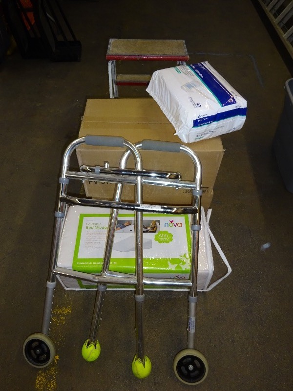 lot 35 image: Walker, diapers, bed wedge and step stool