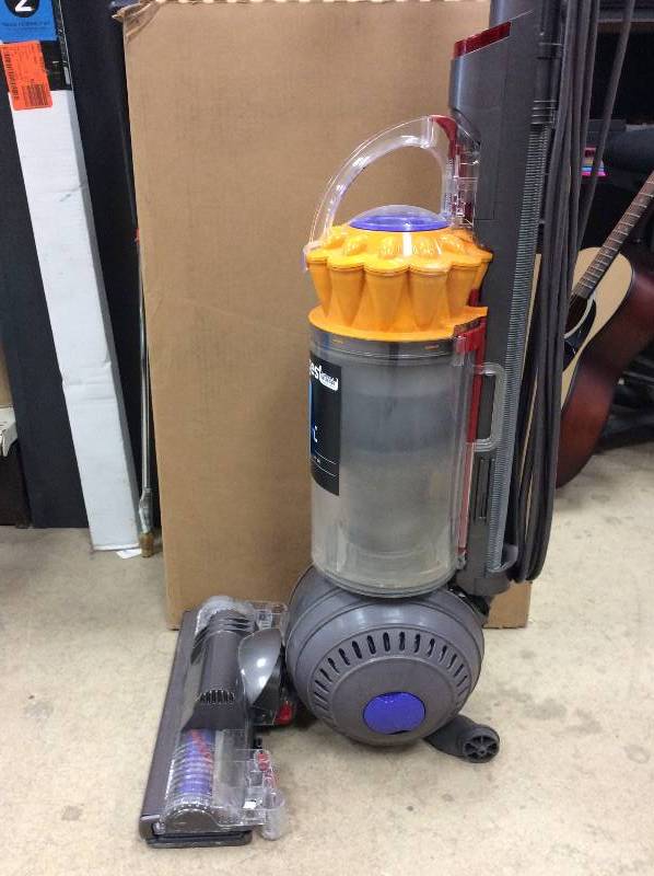 lot 1 image: Dyson Multi Floor Vacuum used- works but it is missing a wheel see pictures
