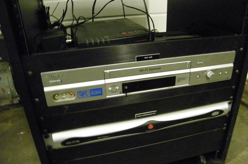 lot 61 image: Middle Atlantic Equipment Rack with Polycom VSX, Sony VCR & More