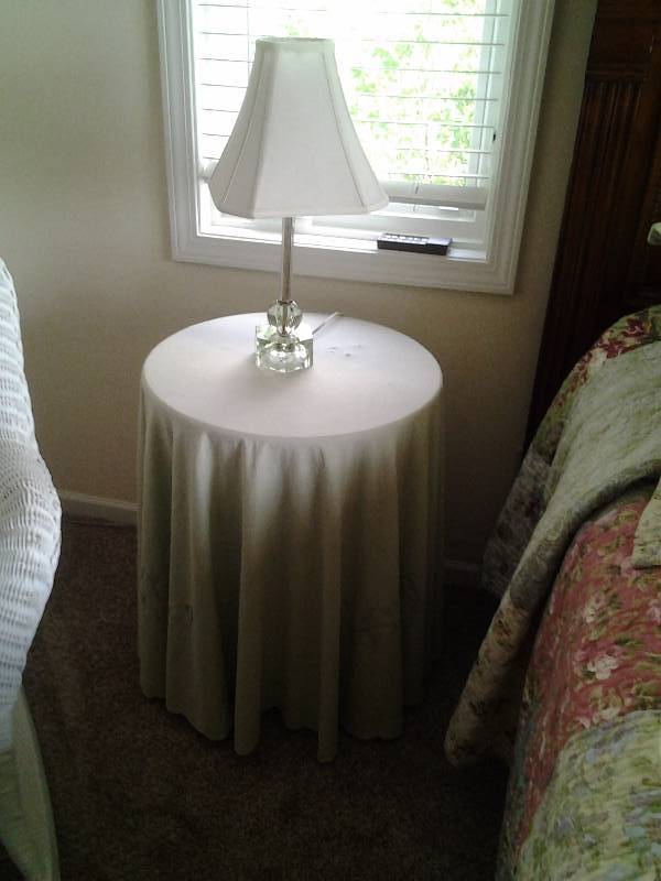 lot 104 image: Round Side Table With Sage Green Tablecloth, Vintage Etched Glass Lamp, 2 Wall Sconces