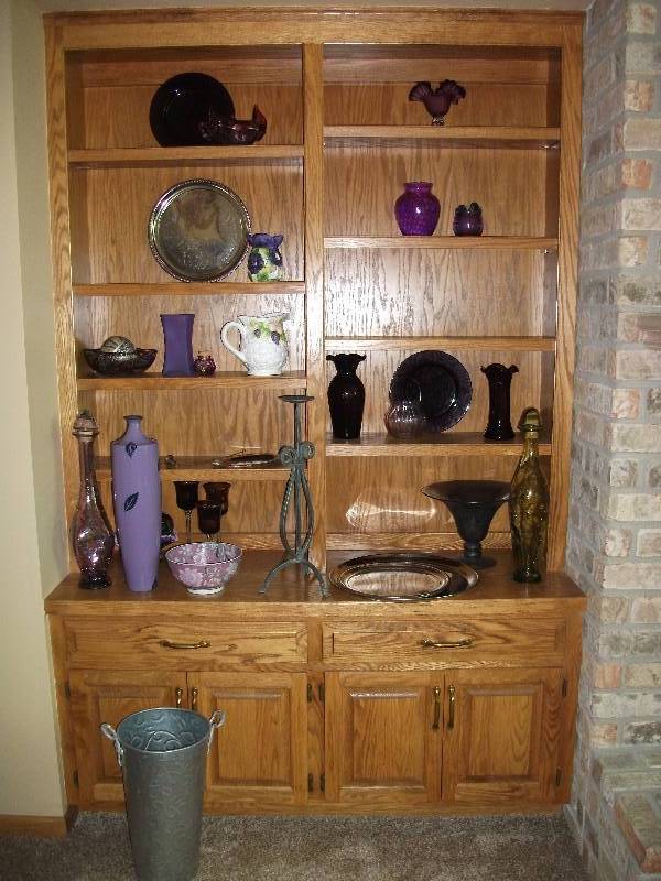 lot 92 image: Contents On Shelf-Pretty Purple, Lilac, Lavender Glassware, Silver Tone Trays, Green Glass Decanter Bring Boxes & Wrapping Supplies