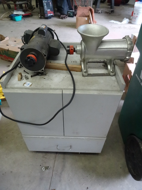 lot 25 image: Meat Grinder on Wood Cabinet on Wheels.