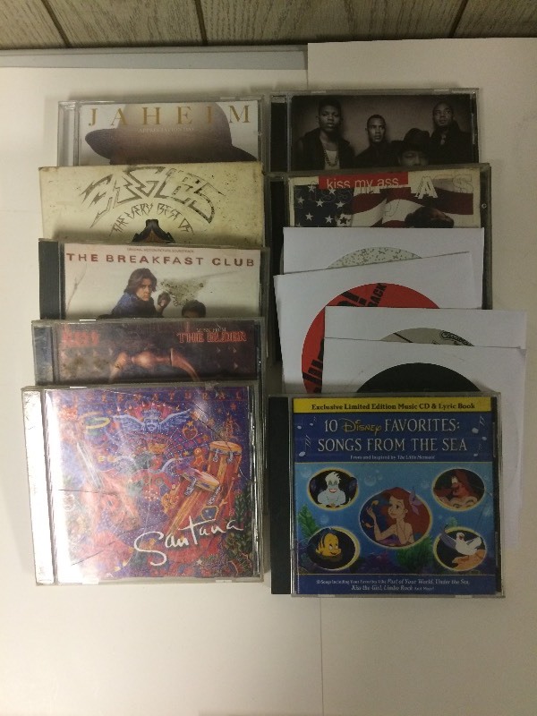 lot 33 image: 12 CDs - Eagles, Kiss, Santana, & more