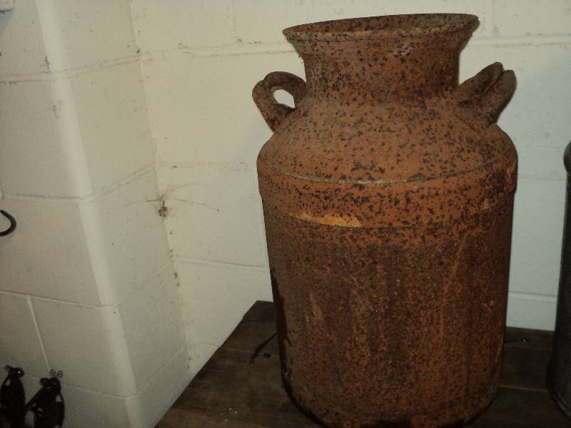 lot 82 image: rusty milk can, 21 in tall...
