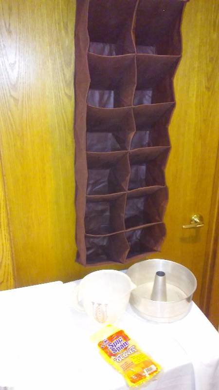 lot 74 image: Over the Door Organizer, Tupperware Brand 4 Cup measuring Bowl, angel food cake pan and more