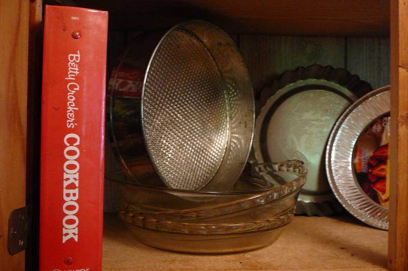 lot 132 image: 3 glass pie baking dishs, 3 metal pie dishs, 9 alum pie, Betty Crocker Cookbook 1988