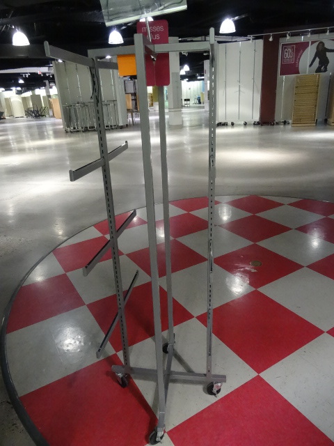 lot 87 image: Metal Retail Clothes Rack on Wheels.