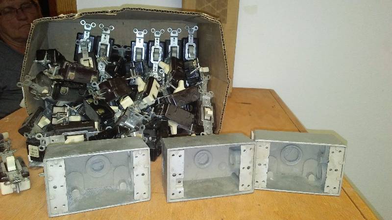 lot 48 image: Single Pole Switches (56) Ivory and exterior outlet boxes (3)