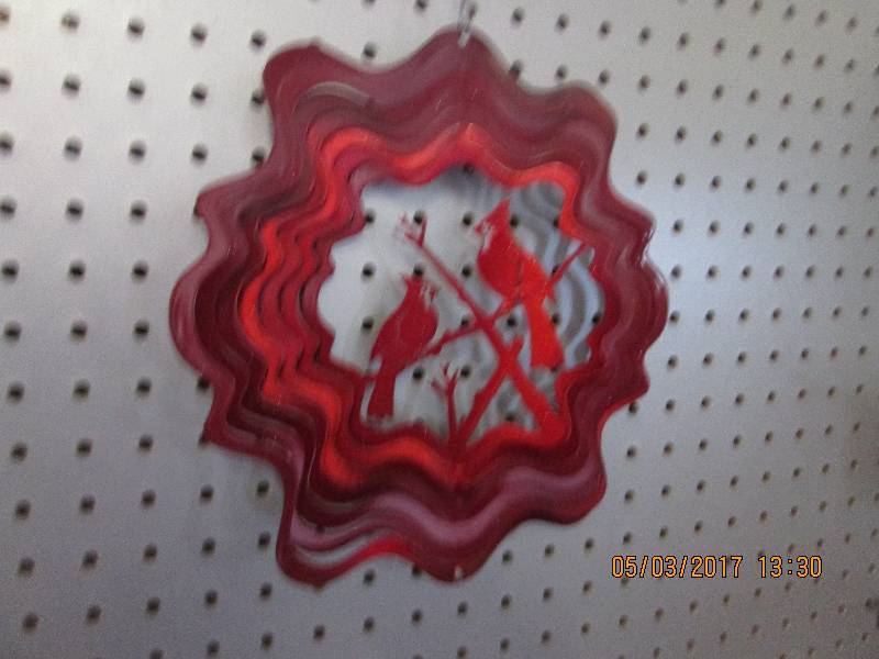 lot 20 image: Metal cardinals wind spinner. 10.25...