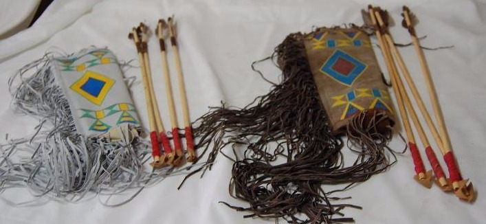 lot 33 image: Two Toy Leather Quivers with Arrows