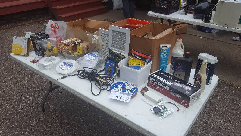 lot 285 image: Table Lot Including Recess Lighting supplies, Motor oil and other car supplies, Commercial door stop, Household vents, and more