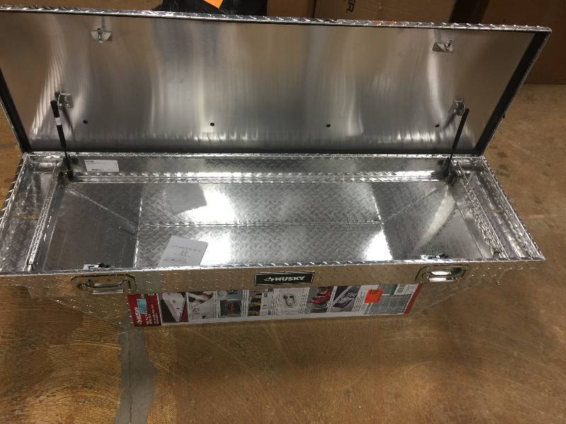 lot 16 image: Husky 62 in. Aluminum Polished Mid Sized Low Profile Truck Box never used Model # THD62LP