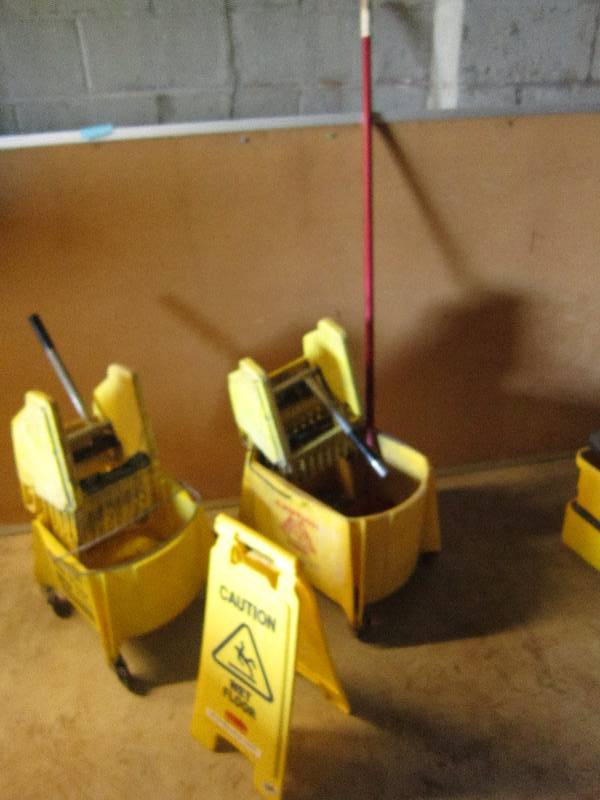 Mop buckets caution sign and mop...