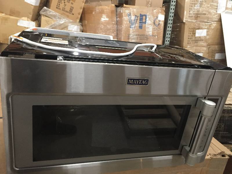 lot 39 image: Maytag 30 in. W 2.0 cu. ft Over the Range Microwave Hood in Fingerprint Resistant Stainless Steel whit small damage on the corner tap missing harware