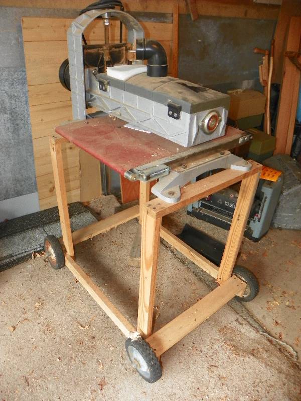 lot 3 image: RYOBI BELT SANDER ON WOODEN STAND WITH WHEELS
