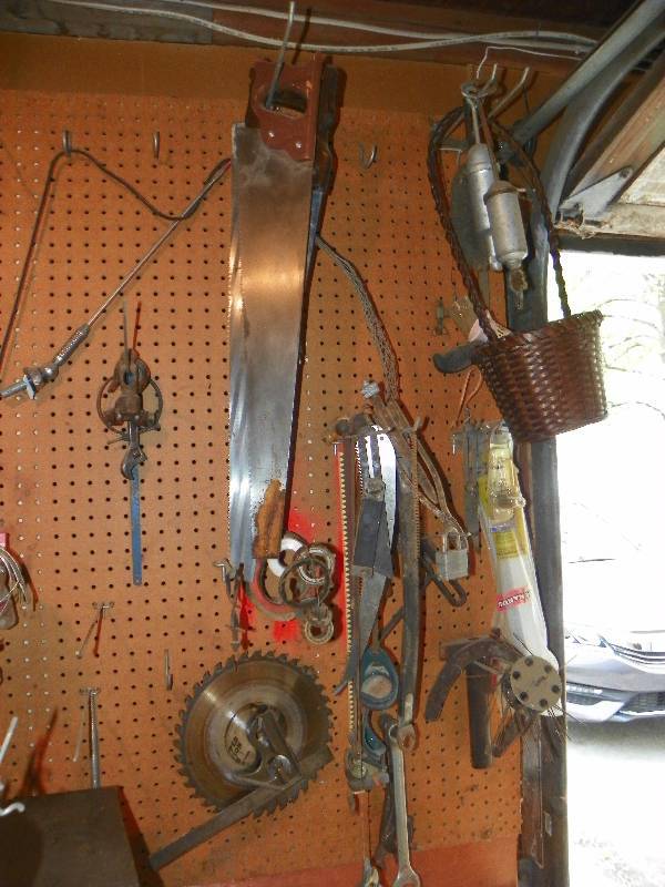 lot 157 image: SAWS AND MISC  TOOLS HANGING ON WALL