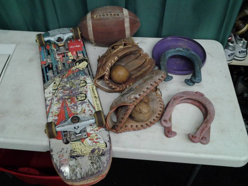 lot 22 image: Leather Baseball Gloves, Horse Shoes, Football, Chocolate Brand Skateboard With Industrial Trucks