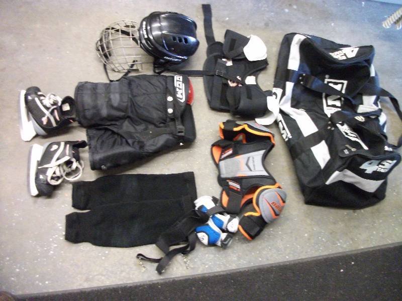lot 50 image: Lot Of Mite Size Hockey Gear-CCM Youth Breezers, Socks, Elbow Pads, Suspenders, Bauer Helmet With Face Guard, Bauer Shoulder & Chest Pads, Joffa Chest Pads, Renegade Skates Size 9