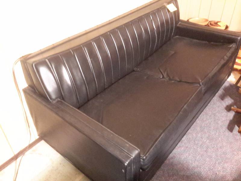 lot 12 image: Mid Century Style couch with simulated leather covering.