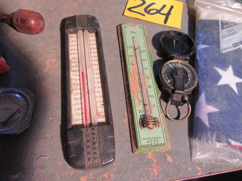 lot 264 image: Misc. Items as pictured.. Including White Gas Camp Stove 2 vintage thermometers, nice compass, American Flag. Other items as pictured.. See closeups