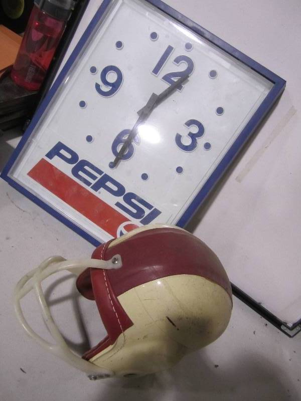 lot 81 image: Pepsi clock and vintage helmet...
