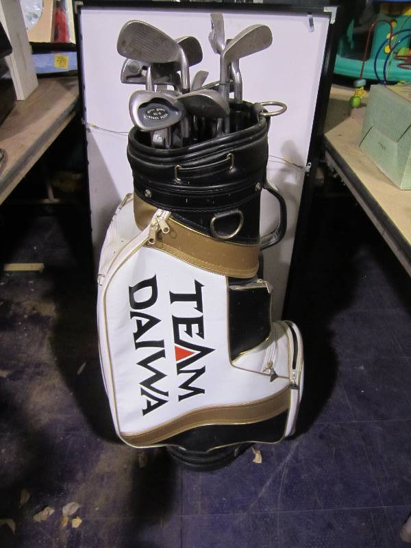 lot 203 image: Team Diawa golf bag with golf clubs...