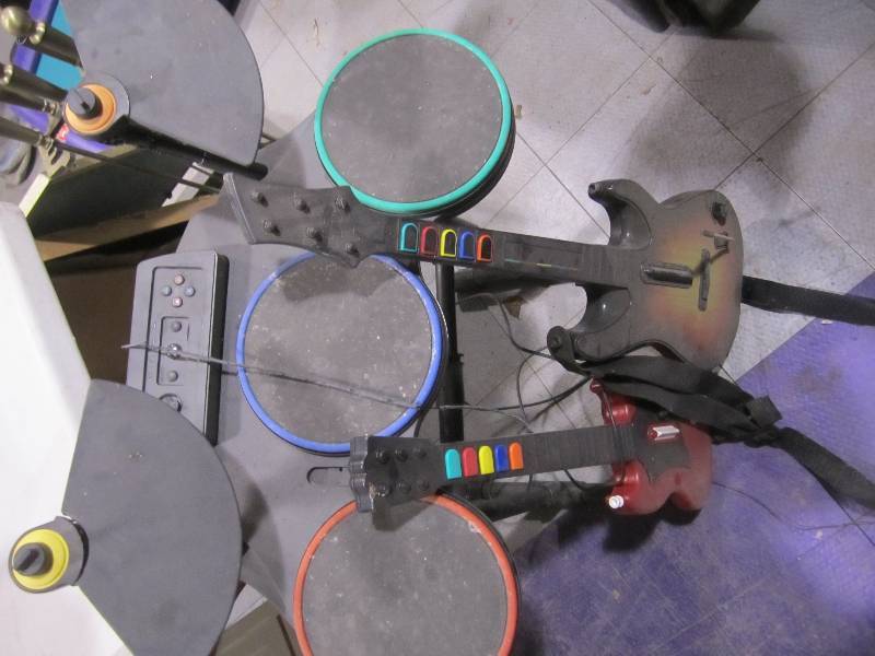 lot 219 image: Guitar hero drum set and two guitar...