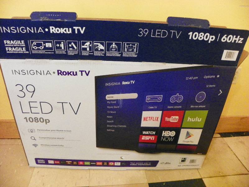 lot 38 image: INSIGNIA 39 LED TV HUNG ON THE WALL
