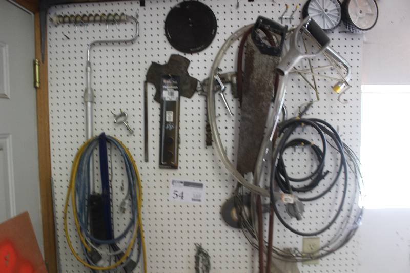 lot 54 image: Wall Contents Includes Saw, Hoses, Cords, Wheels