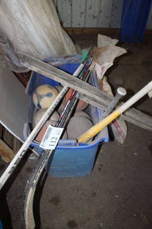 lot 112 image: Bucket Lot of Sporting Equipment Includes Bats, Hockey Sticks, Soccer Balls, Basketball, And More