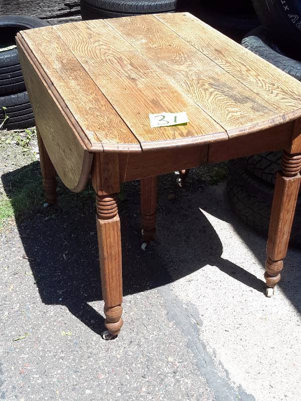 lot 31 image: Oak Table.. Could be repaired. It is just set together.  5 Porcelain Wheels as shown..