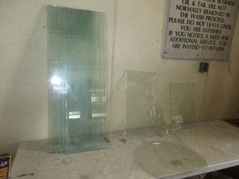 lot 76 image: 7 - 14 x 48 thick glass  1 - 23 diameter circle glass  3 - misc sizes