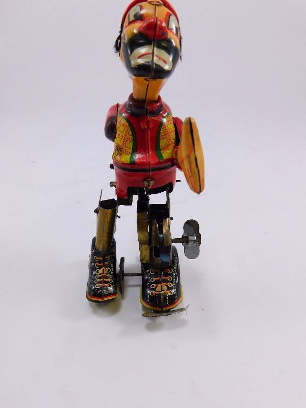 lot 25 image: Vintage Tin Litho Roller Skating ClownHobo