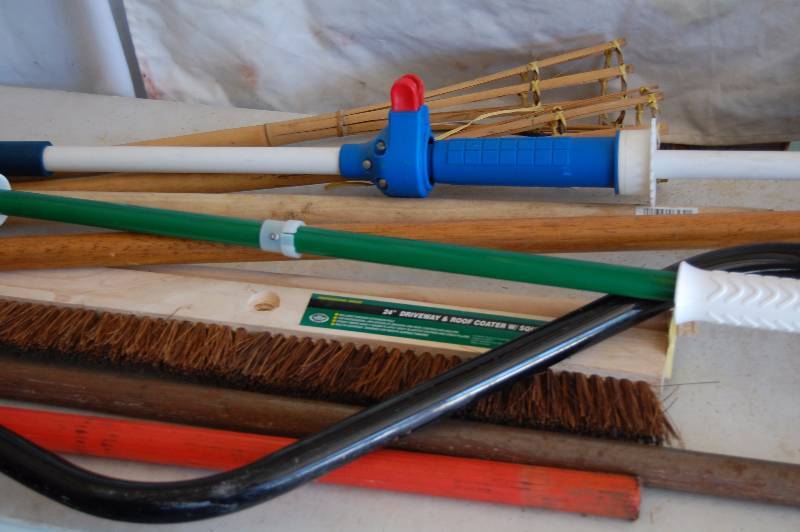 lot 98 image: Tiki Torches, Driveway Brush and Tool Handles